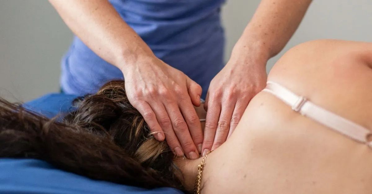 A massage therapist massaging a patient's neck at REACH Rehab + Chiropractic, Plymouth MI